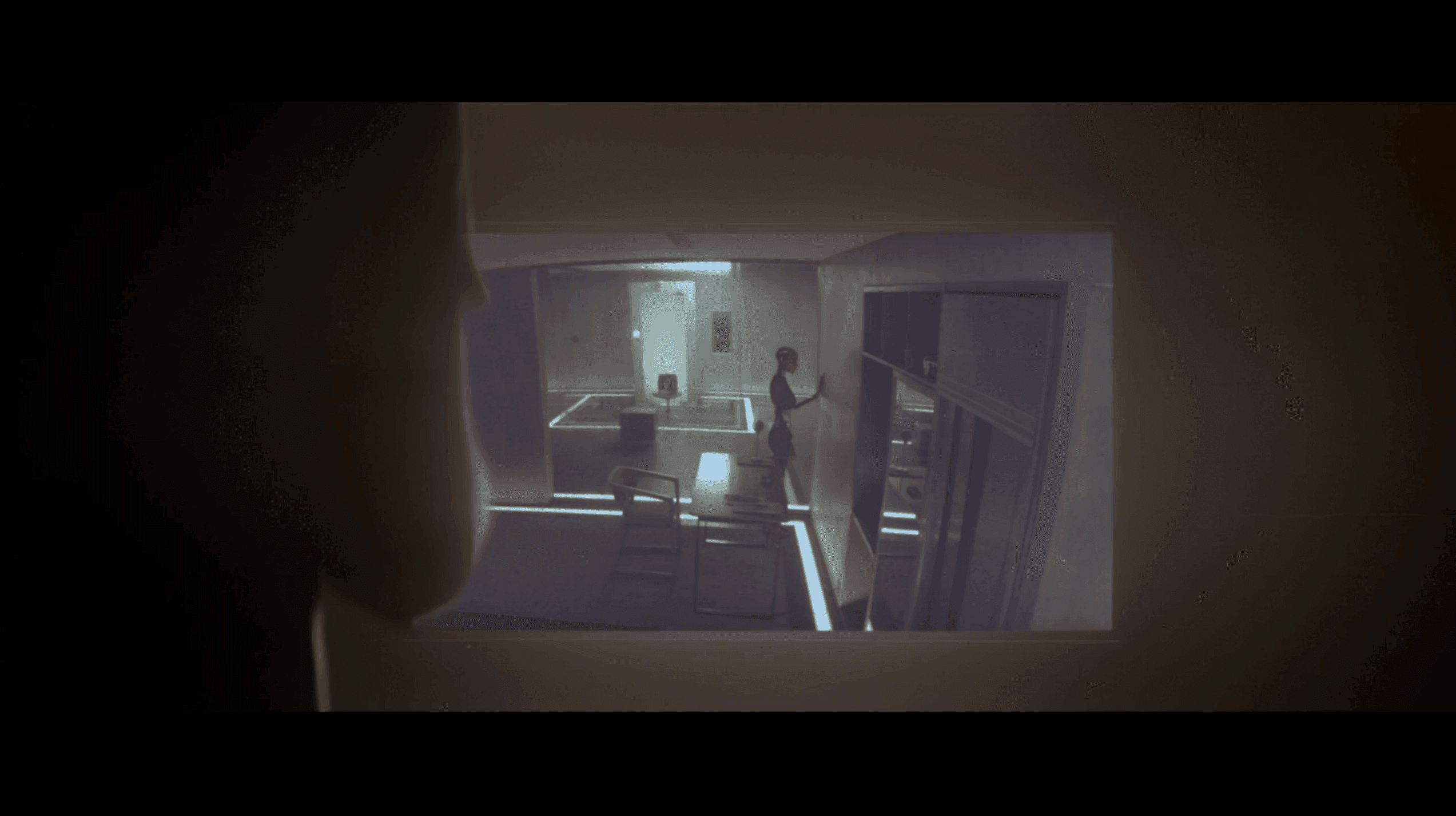 Ex Machina movie protagonist watching the robot on a TV screen